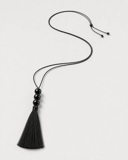 Alternate complete Nera black tassel necklace in an asymmetric curve with sliding knot and tails