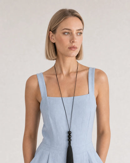 Alternate European-summer portrait featuring the Nera black bead tassel necklace