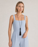 Human-scale summer portrait showing the long Nera black tassel necklace