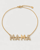 Noa gold articulated MAMA necklace on a seamless pale dove-grey studio background