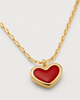 Macro view of the glossy crimson heart and polished gold border