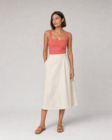 Wide studio portrait in coral and ivory linen featuring the Noemie necklace