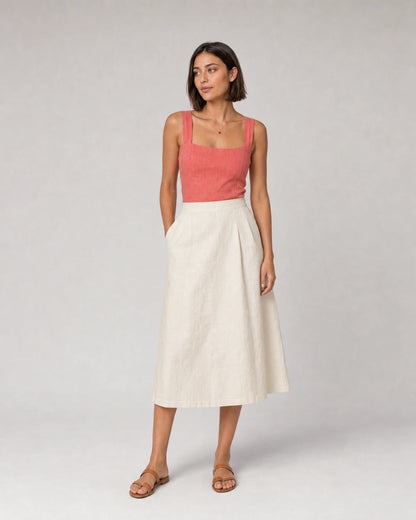 Wide studio portrait in coral and ivory linen featuring the Noemie necklace