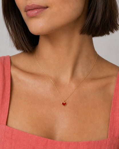 Close wearing view of the petite Noemie crimson heart and fine gold chain