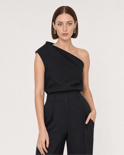 Human-scale studio view of the Nysa earrings with black tailoring