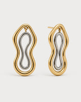 Pair of Nysa gold and silver sculptural figure-eight studs on seamless pale dove-grey