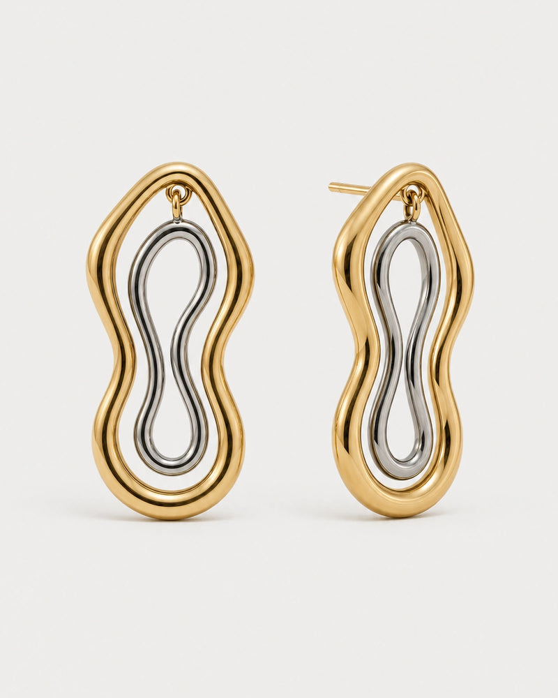 Pair of Nysa gold and silver sculptural figure-eight studs on seamless pale dove-grey