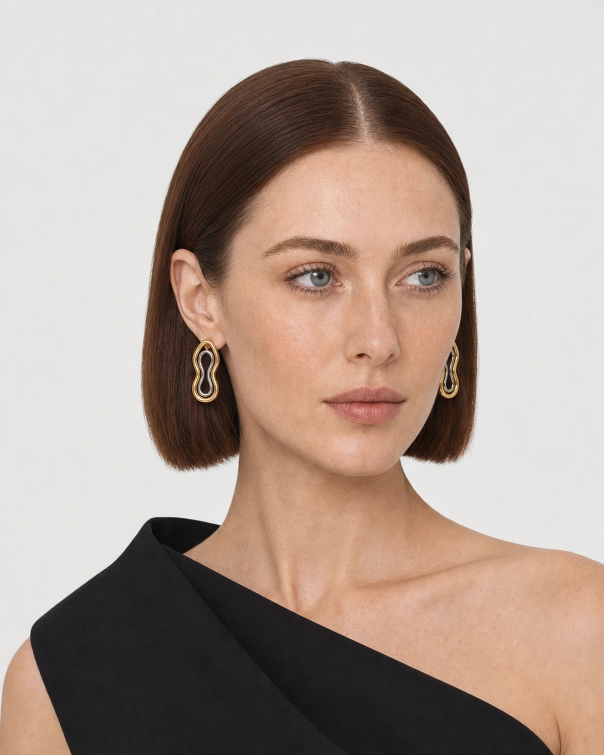 Alternate portrait of the same model wearing the Nysa earrings