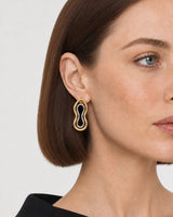 Close ear view of one Nysa gold frame and suspended silver insert