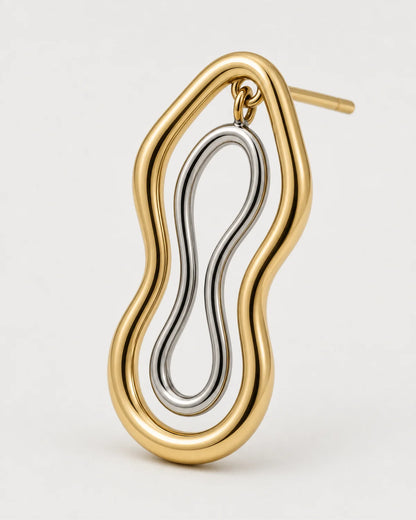 Macro of the Nysa warm-gold outer frame and suspended silver figure-eight insert