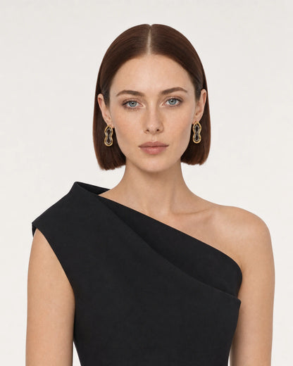 Model in a black asymmetric summer top wearing Nysa mixed-metal earrings