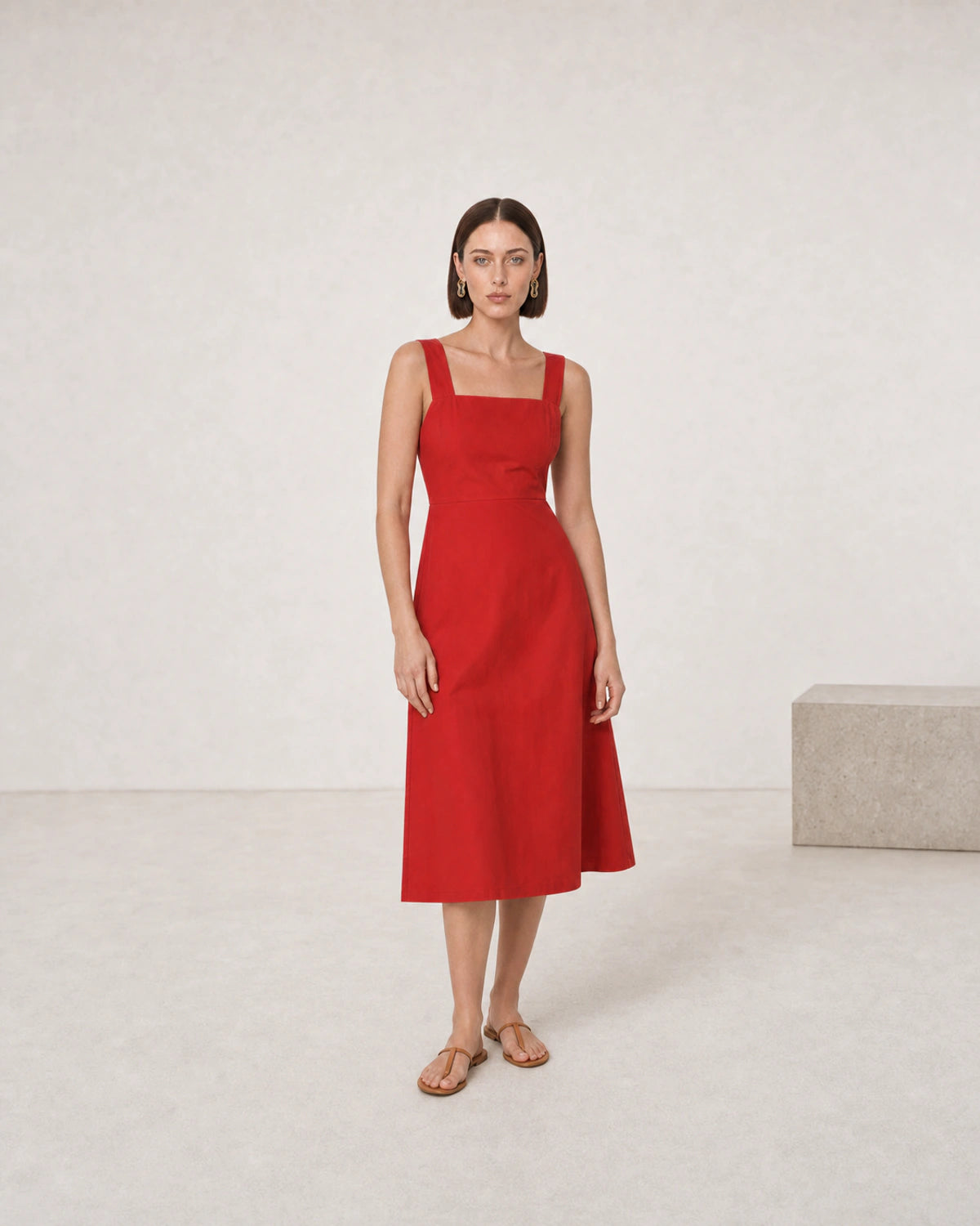 Full-body tomato-red summer dress portrait featuring Nysa sculptural earrings
