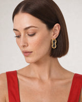 Close wearing view of the Nysa gold outer frame and silver inner loop