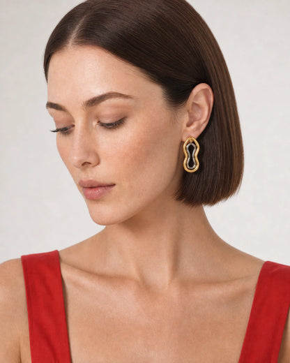 Close wearing view of the Nysa gold outer frame and silver inner loop