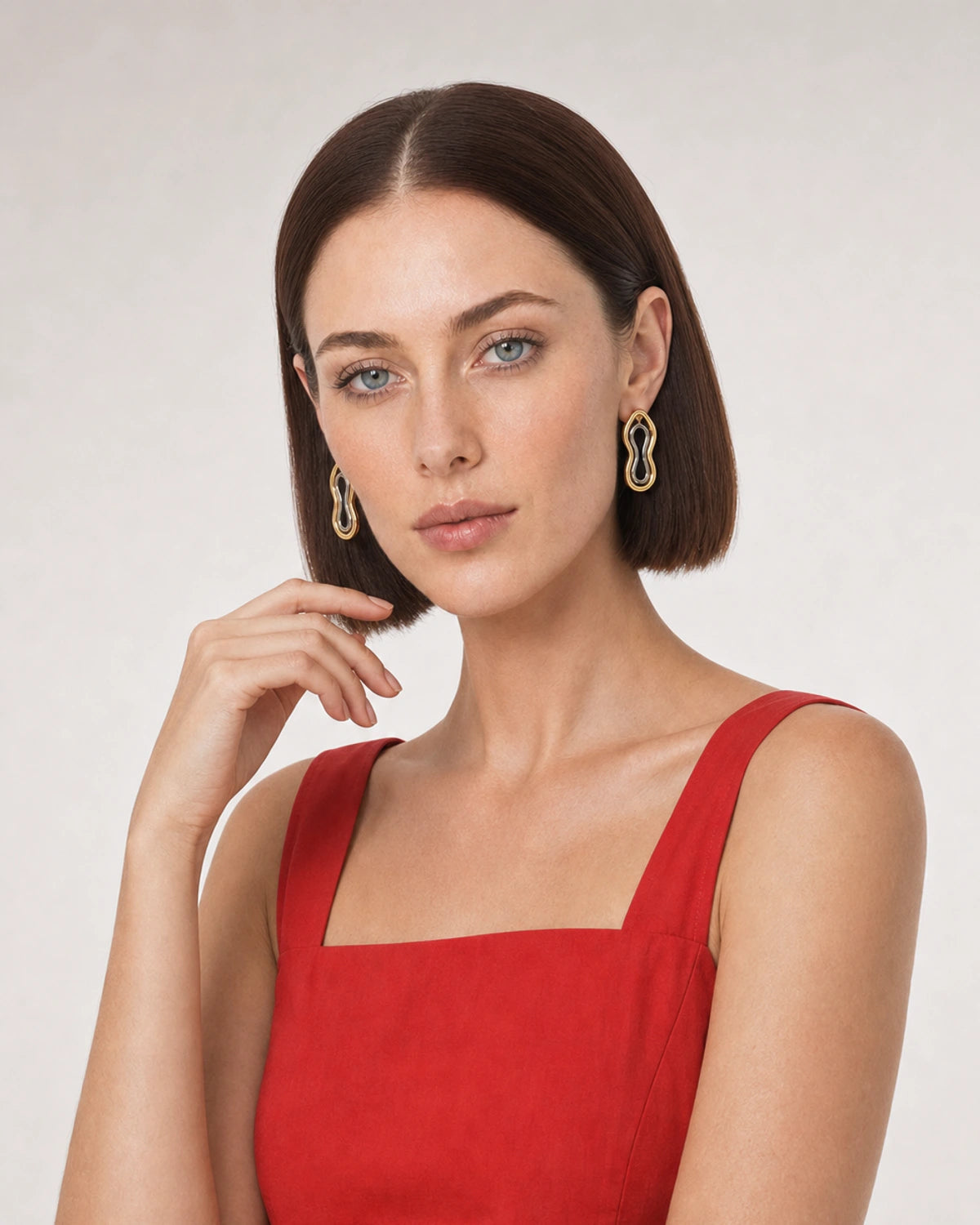 Human-scale portrait showing the Nysa mixed-metal earrings