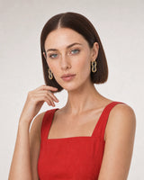 Human-scale portrait showing the Nysa mixed-metal earrings