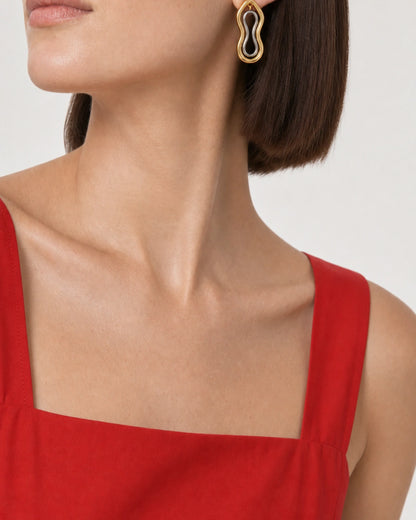 Eye-free lower-face and ear studio crop of Sienna wearing a Nysa mixed-metal earring