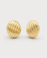 Odette gold ribbed oval stud earrings on pale dove-grey