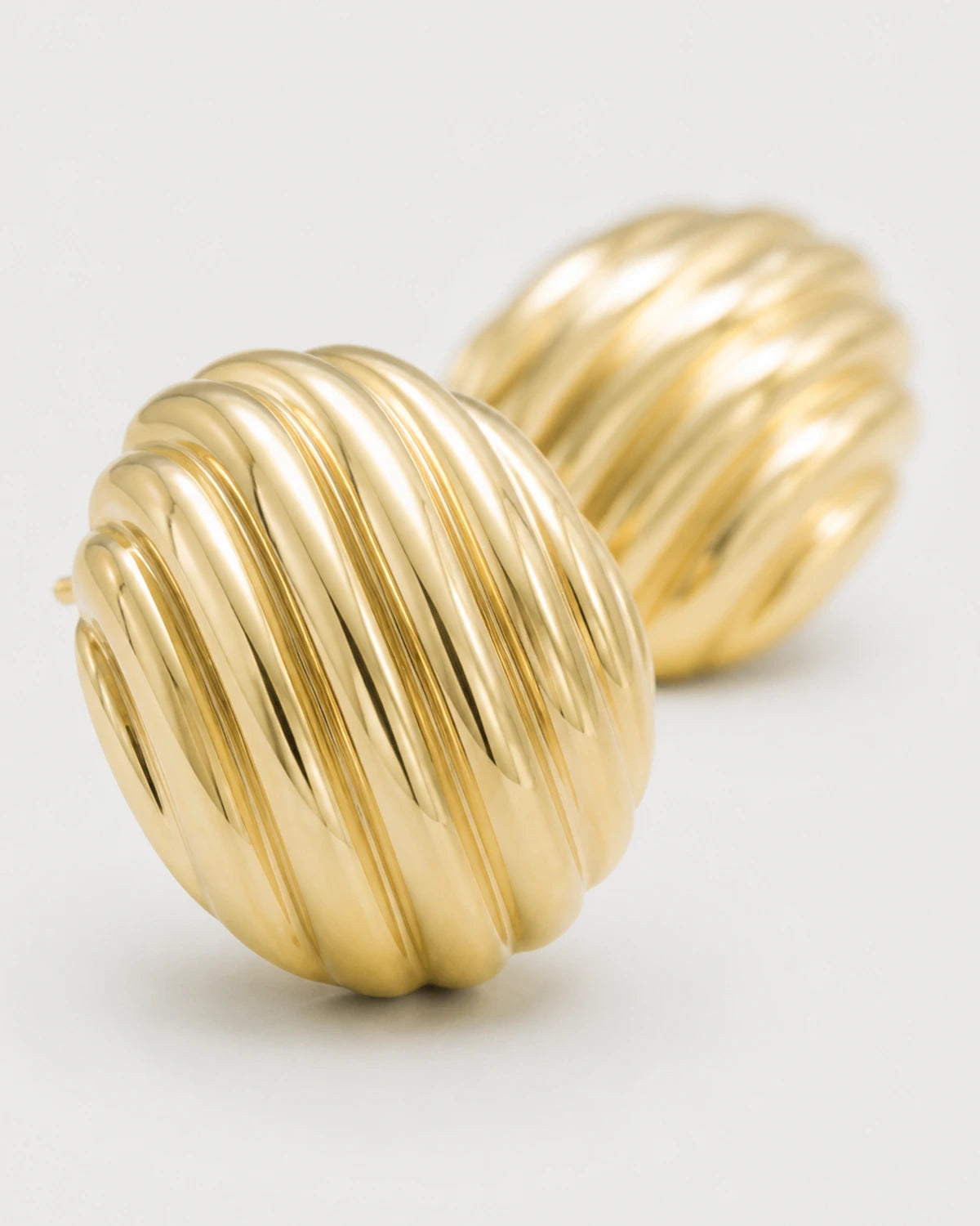 Macro view of the polished diagonal ribs on the Odette gold studs