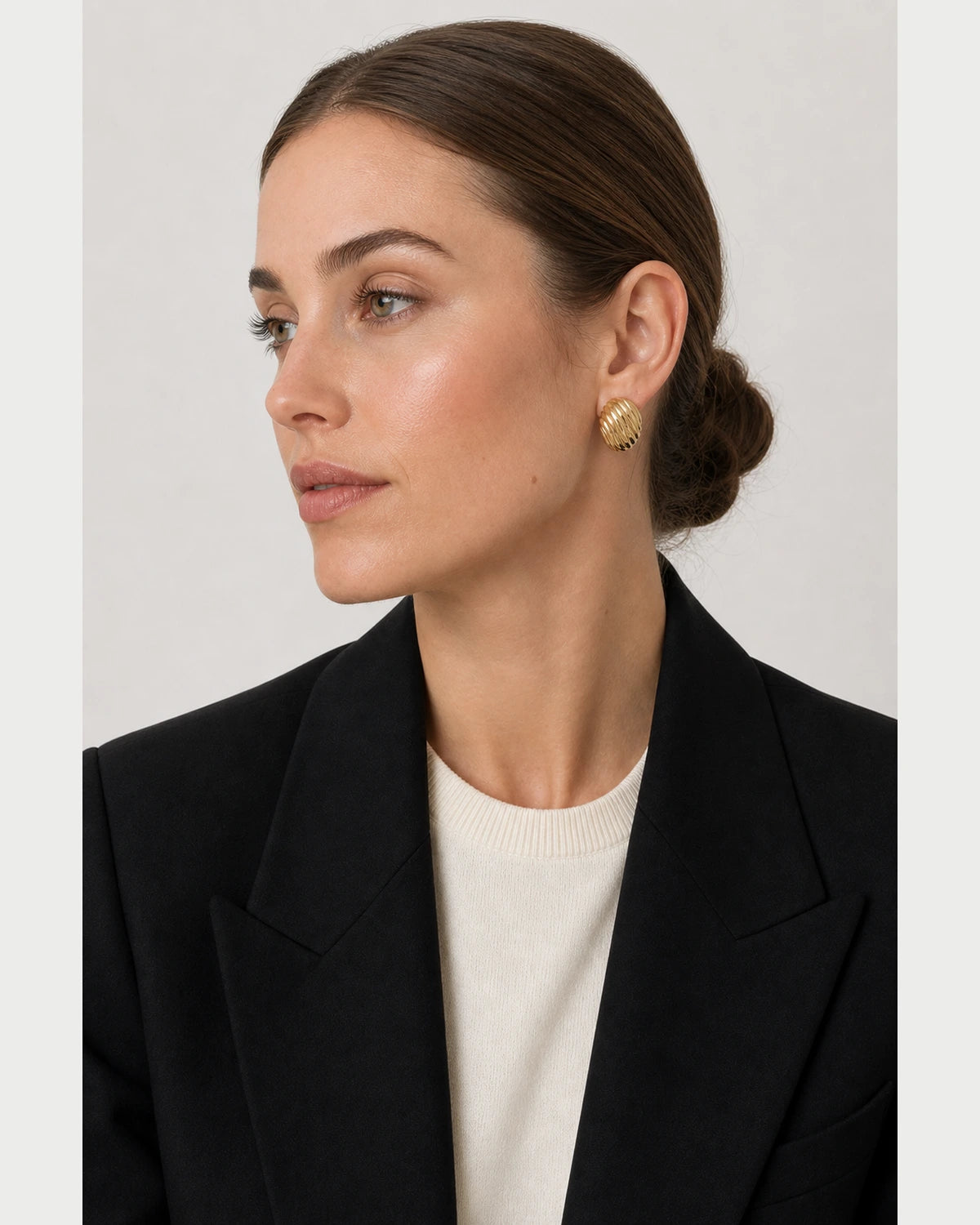 British model in black and ivory tailoring wearing the Odette studs