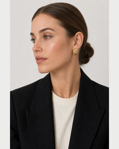 British model in black and ivory tailoring wearing the Odette studs