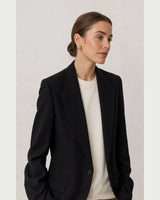 Wide grey-studio editorial portrait featuring the Odette gold studs