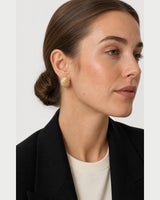 Close side portrait showing the Odette ribbed oval earring