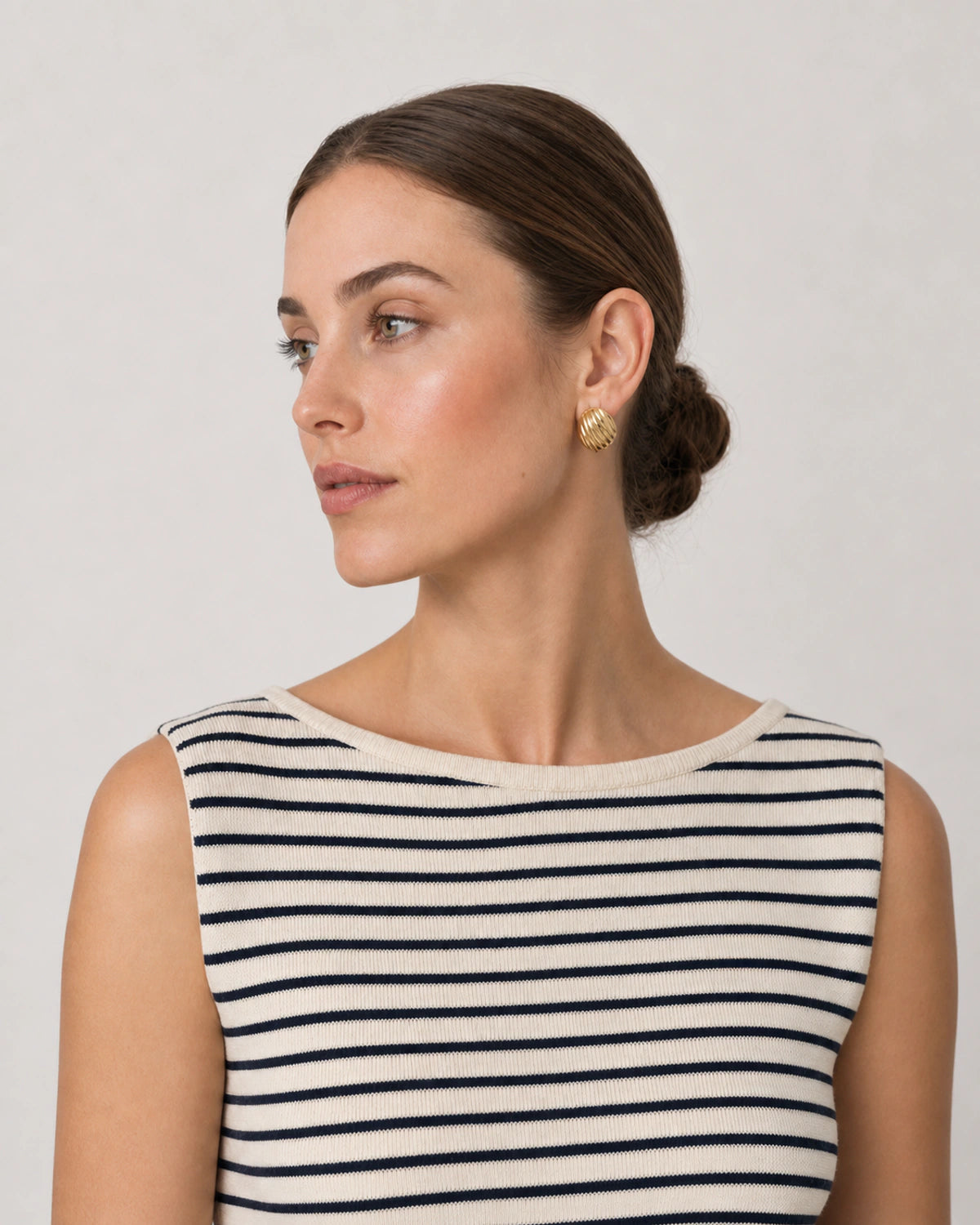 Alternate Riviera portrait featuring the Odette sculptural gold studs