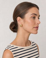 Close side portrait showing the Odette ribbed gold oval stud