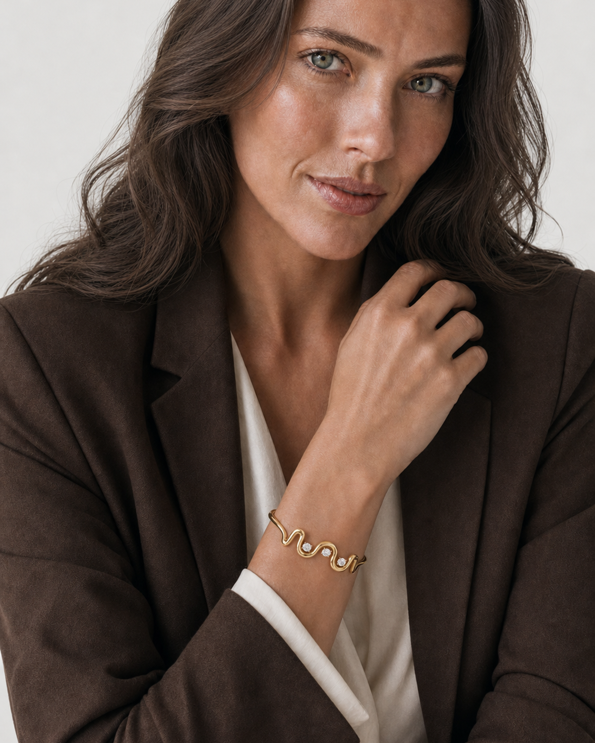 Australian model aged 25 to 28 wearing the Onda Crystal Wave Cuff in a pale dove-grey studio