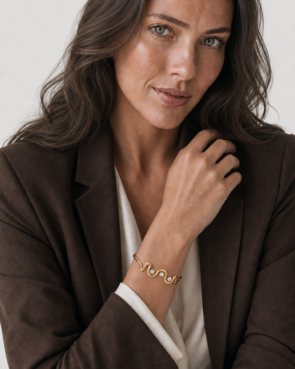 Australian model aged 25 to 28 wearing the Onda Crystal Wave Cuff in a pale dove-grey studio