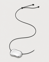 Alternate full-length view of the adjustable Orra black cord necklace on pale dove-grey