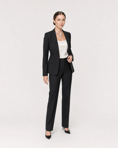 Wide studio portrait showing the Orra necklace with black tailoring at natural scale