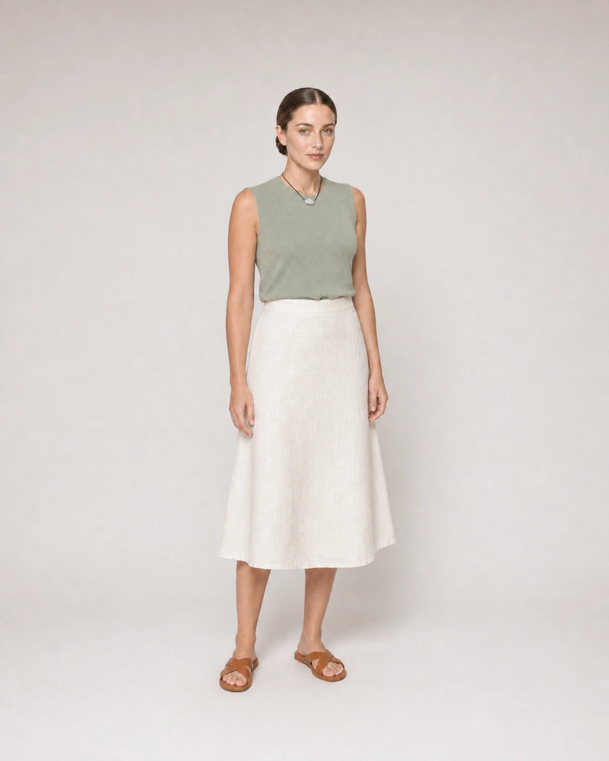 Wide studio portrait in sage knit and ivory linen featuring the Orra necklace