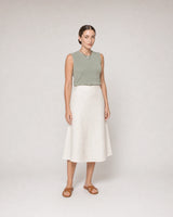 Wide studio portrait in sage knit and ivory linen featuring the Orra necklace