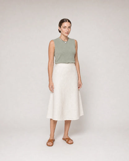 Wide studio portrait in sage knit and ivory linen featuring the Orra necklace