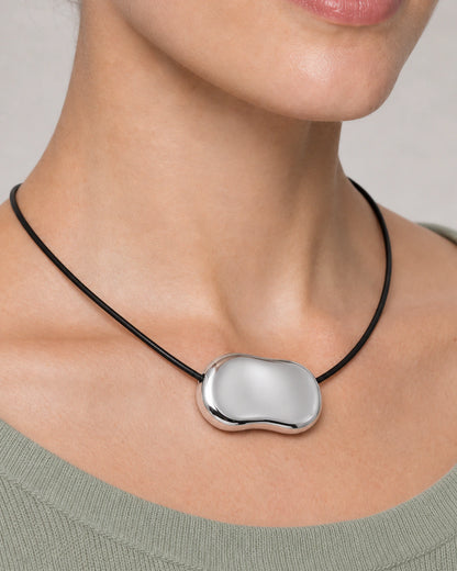 Extreme wearing macro of the Orra side-threaded silver bean pendant