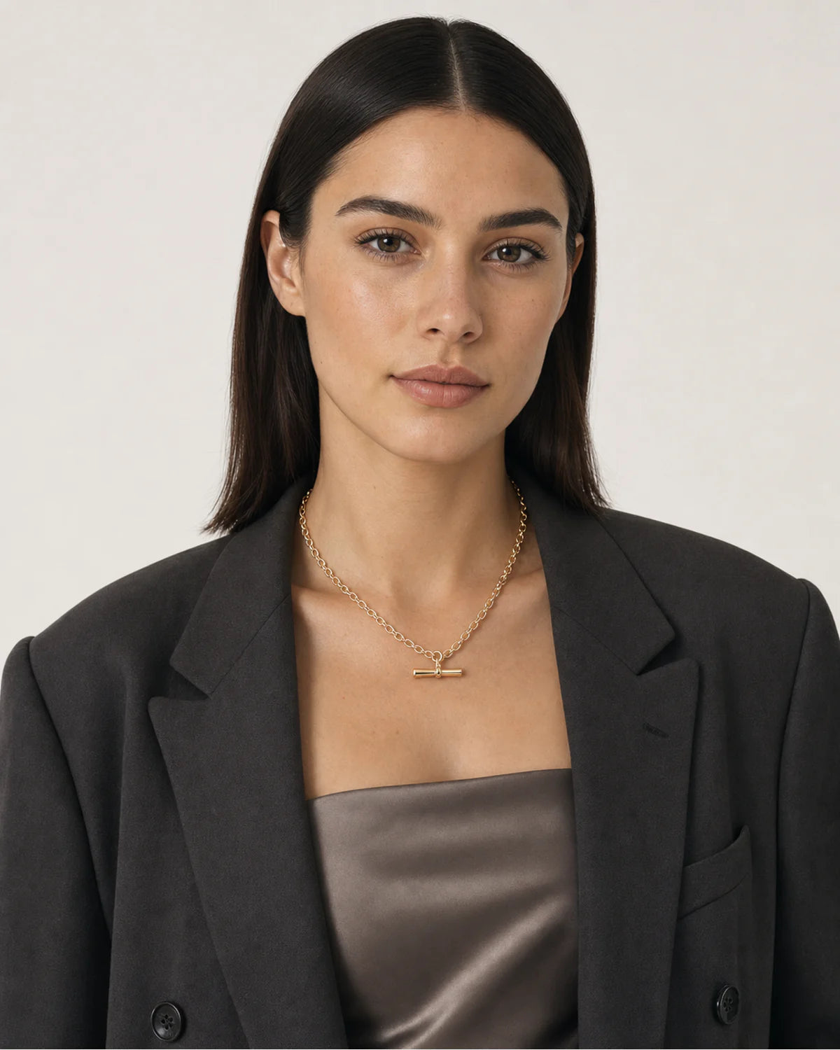 Australian model wearing the Romy T-bar necklace with a charcoal blazer