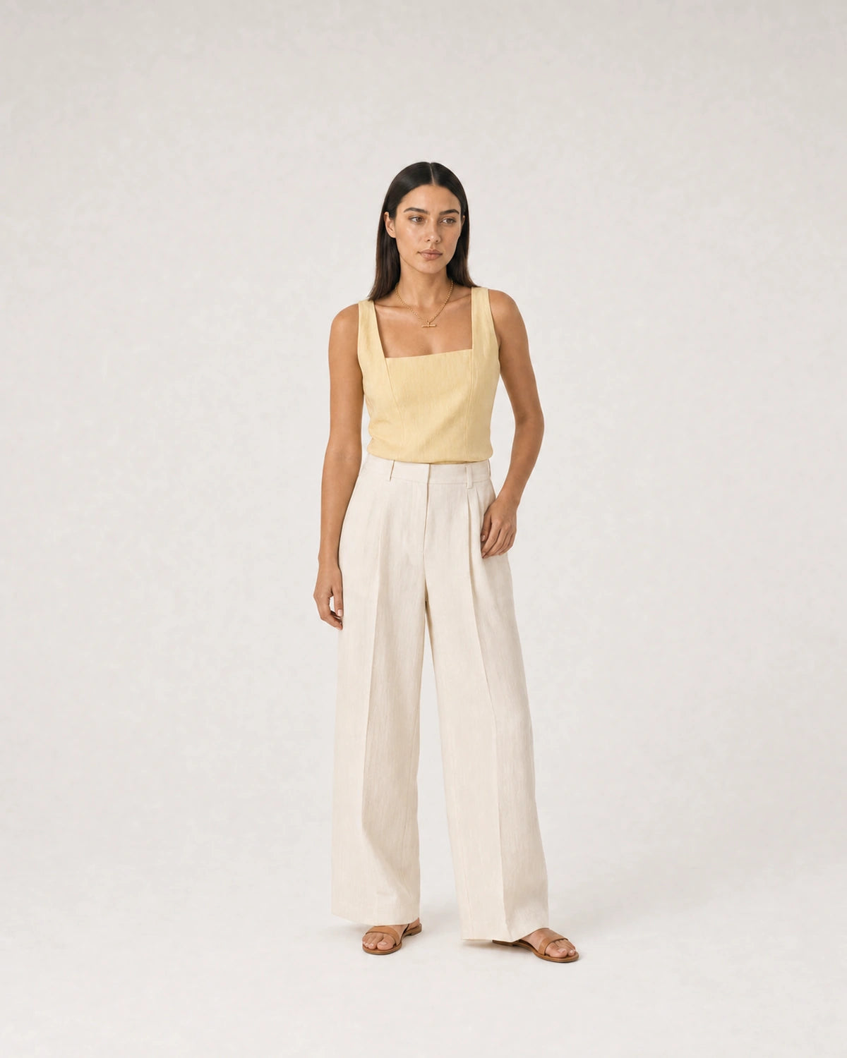 Wide summer studio portrait in yellow linen and ivory trousers featuring Romy