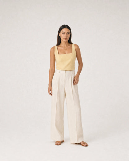 Wide summer studio portrait in yellow linen and ivory trousers featuring Romy