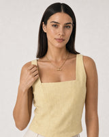 Human-scale summer portrait showing the Romy gold T-bar necklace