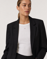 Wide grey-studio portrait featuring the Rosalie red heart necklace