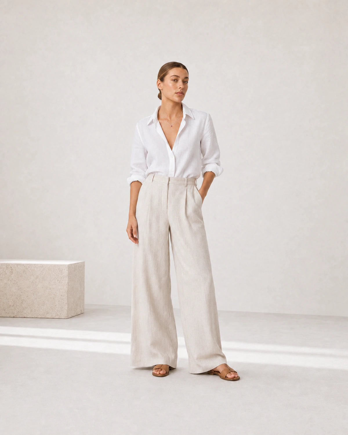 Full-body white and stone linen portrait featuring the Rosalie red heart necklace