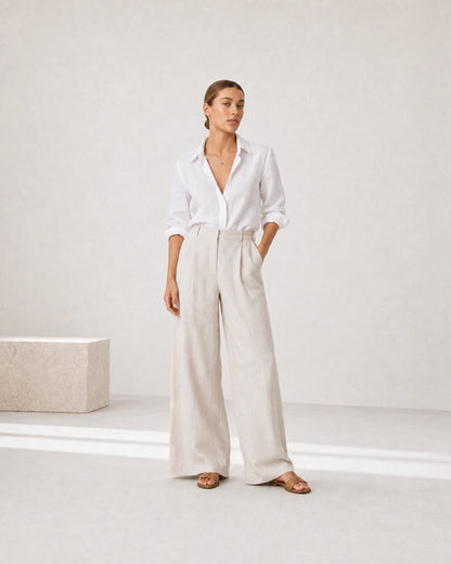 Full-body white and stone linen portrait featuring the Rosalie red heart necklace