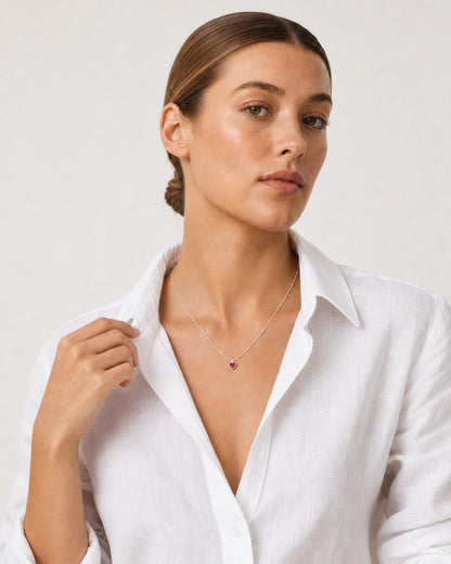 Human-scale portrait showing the petite Rosalie red heart pendant
