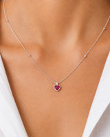 Extreme on-body macro of the Rosalie ruby-red heart and silver bead stations