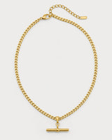Sabine gold curb T-bar necklace on a pale dove-grey background