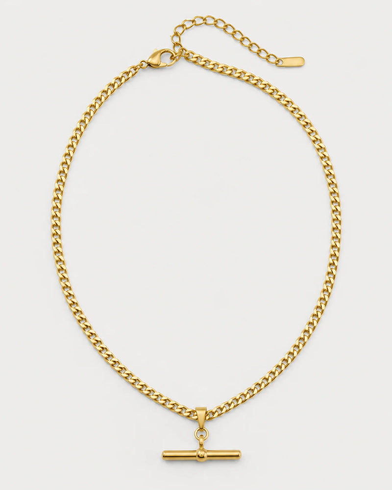 Sabine gold curb T-bar necklace on a pale dove-grey background