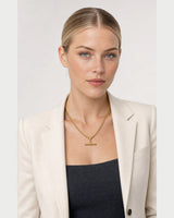 American model wearing the Sabine curb T-bar necklace with an ivory blazer