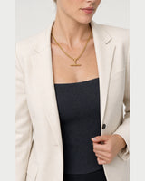 Model holding her blazer lapel while wearing the Sabine curb necklace